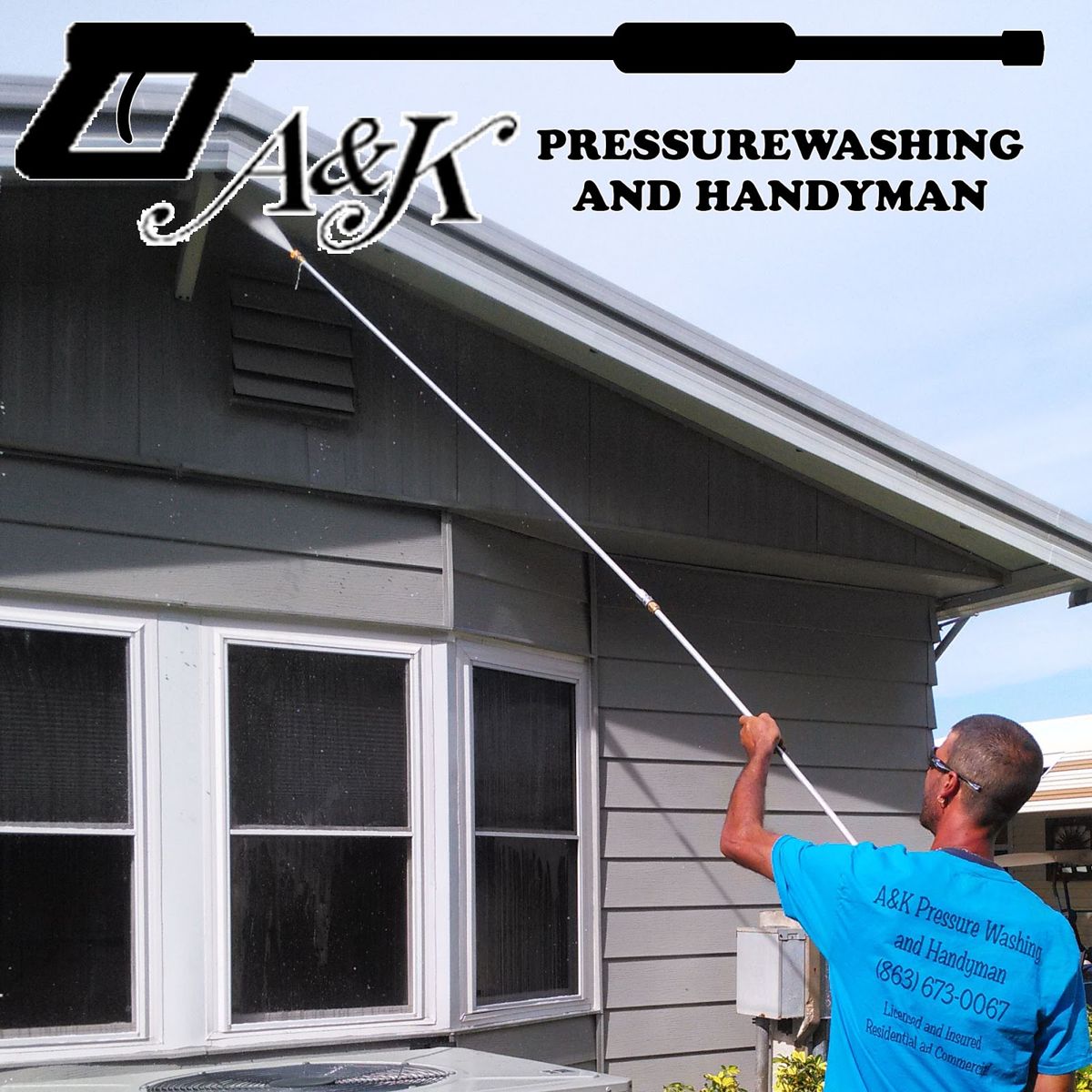 A&K crew member in a blue A&K shirt pressure washing the gable of a grey house
