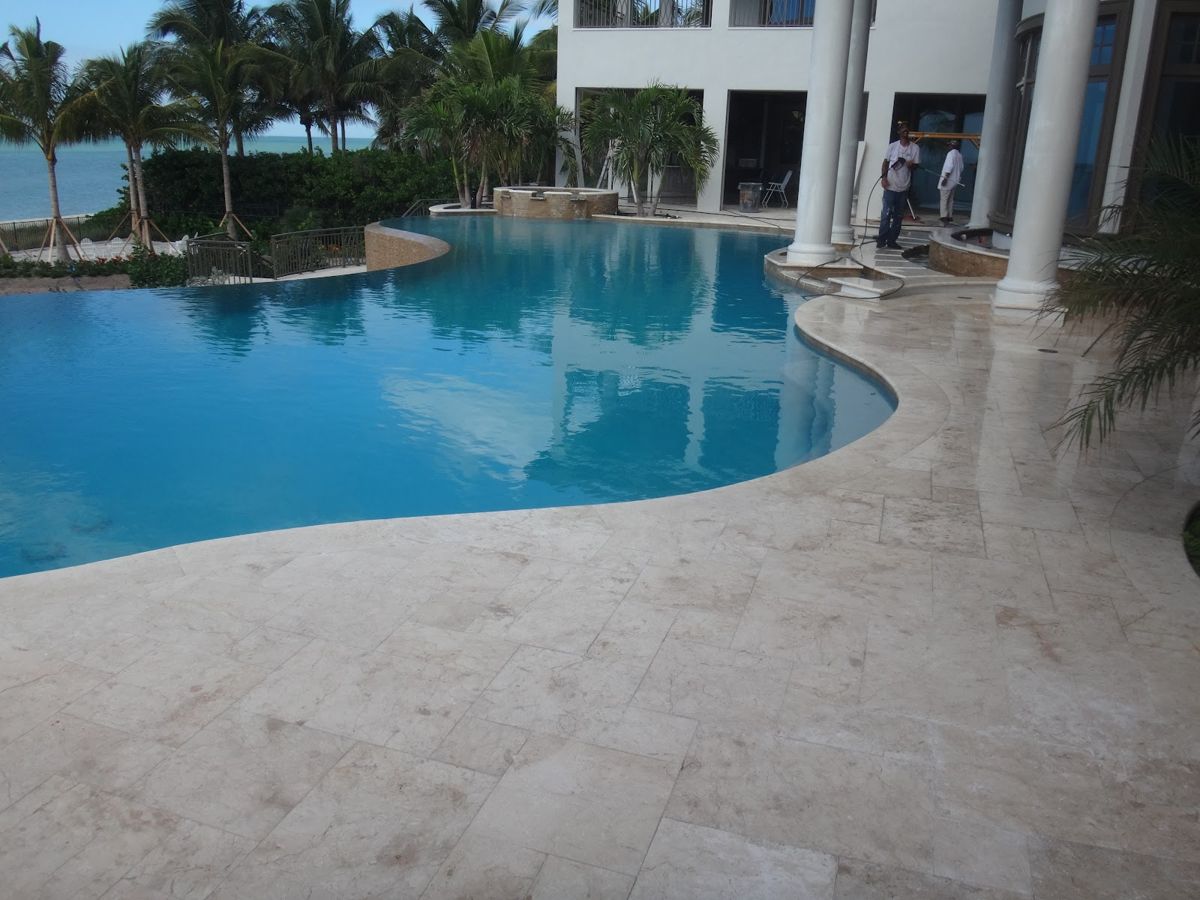 Large pool with a light stone deck